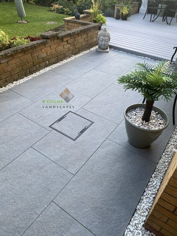 Grey patio and landscaping by K Collier Landscapes