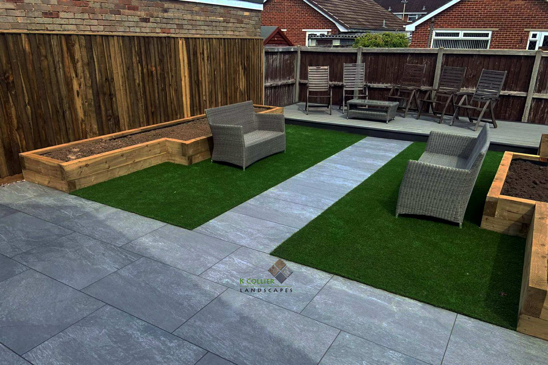 Grey porcelain patio with sleeper beds and lawn