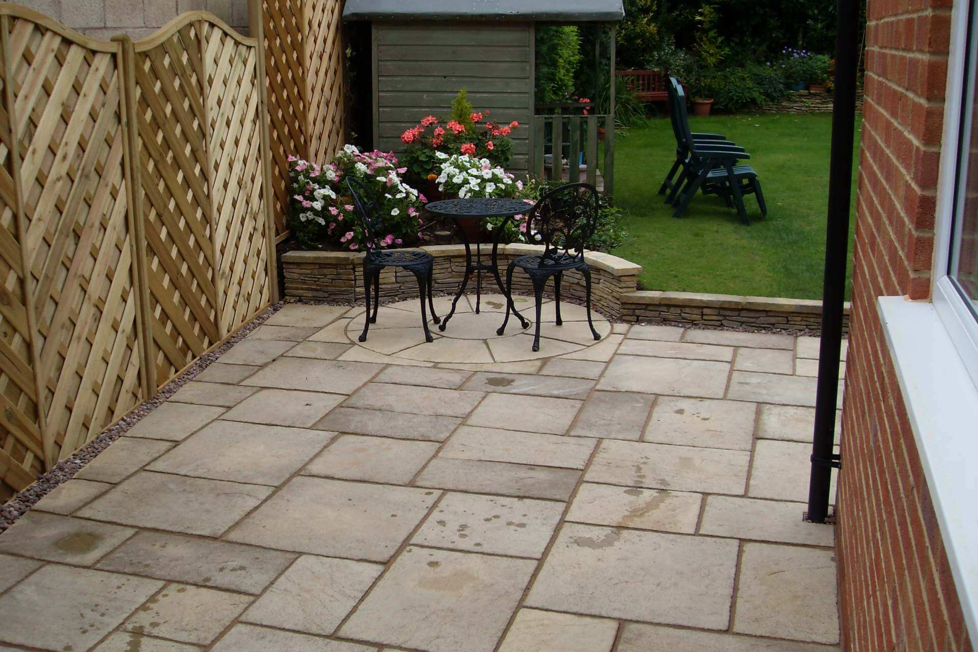 Sandstone patio with circle feature and willow fencing