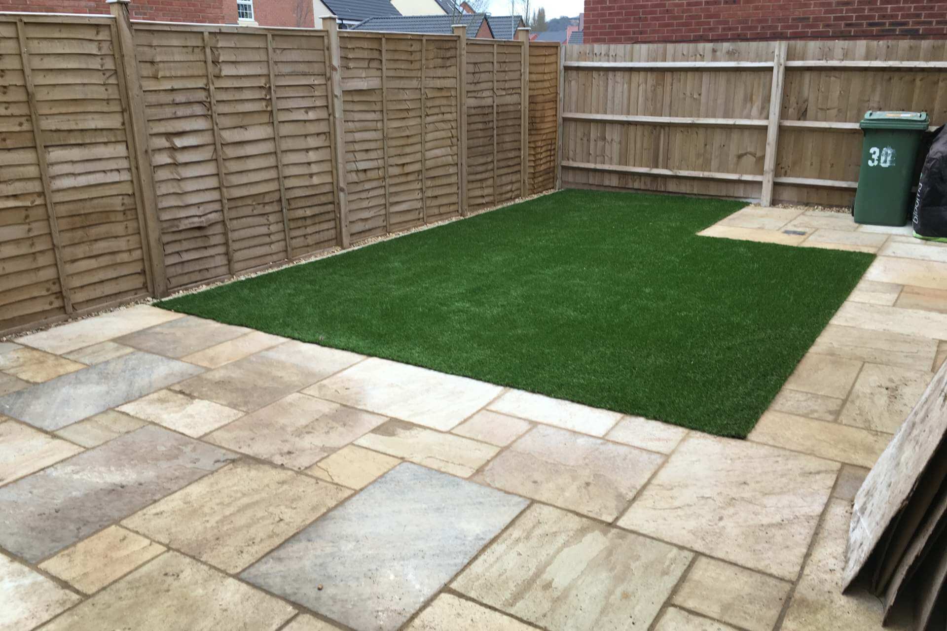 Sandstone patio with artificial lawn